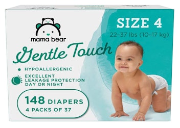 Crawling baby boy in diaper on teal and white Mama Bear diaper packaging
