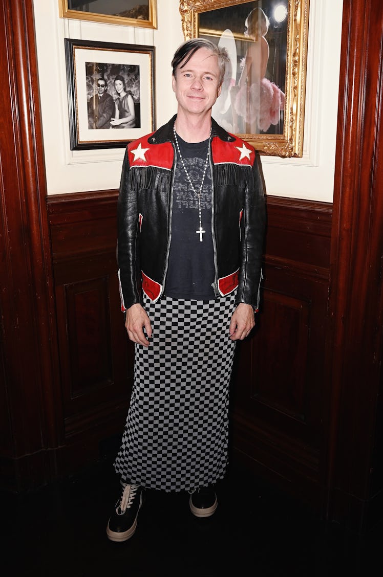 John Cameron Mitchell wearing a long checkered skirt