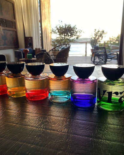 Various perfumes created by Vyrao lined up next to each other, each a different color