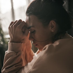 Stock image of a grieving woman.