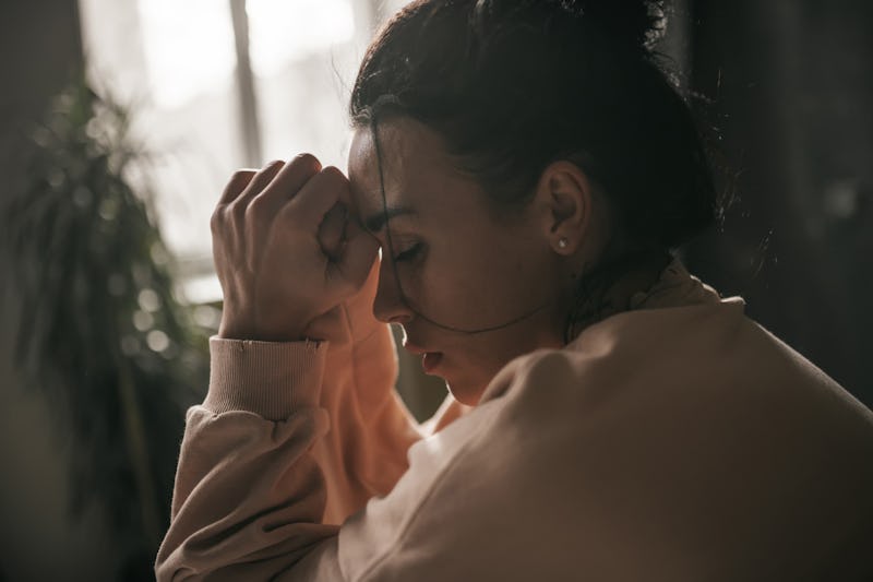 Stock image of a grieving woman.