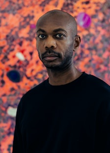 A portrait of Alteronce Gumby in front of one of his works 