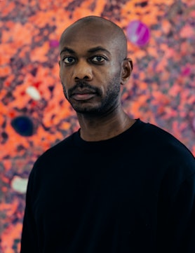 A portrait of Alteronce Gumby in front of one of his works 