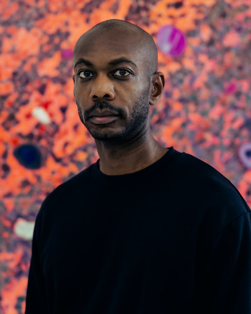 A portrait of Alteronce Gumby in front of one of his works