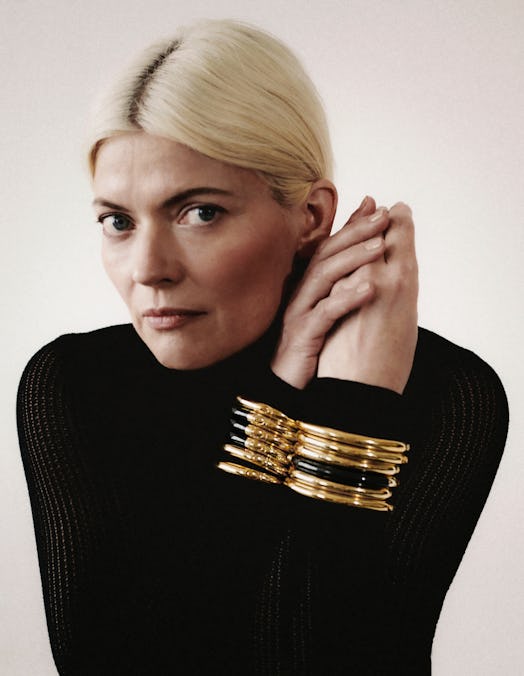 A model in a black turtleneck and chunky gold bracelets by Monica Vinader x Kate Young 