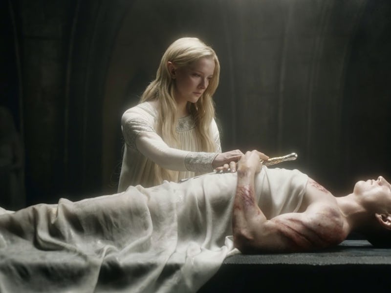 Galadriel stands next to the body of her brother, Finrod, in Episode 1 of The Lord of the Rings: The...