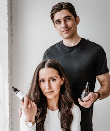 woman and man holding skincare serum