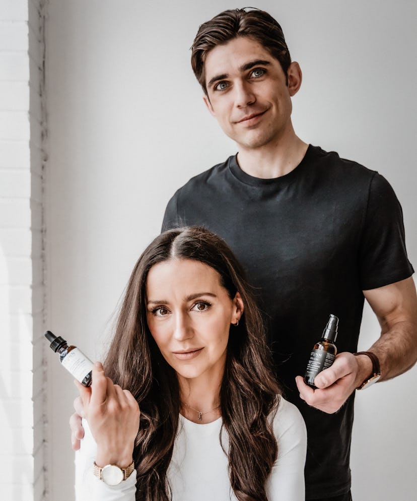 woman and man holding skincare serum
