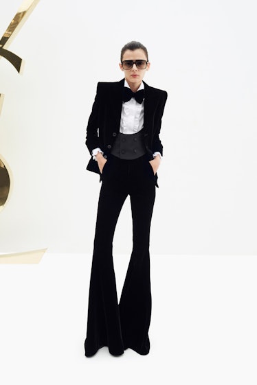 A woman posing in a Saint Laurent black suit