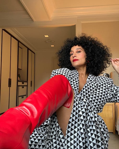 Tracee Ellis Ross wearing red over-the-knee boots.