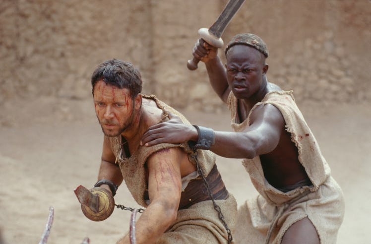 Maximus (Russell Crowe) crouches alongside Juba (Djimon Hounsou) in Gladiator