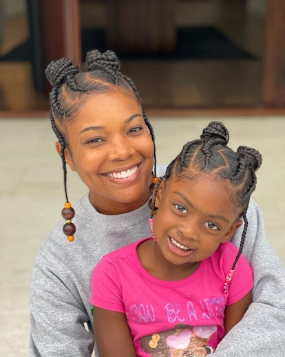 Gabrielle Union and daughter Kaavia matching Fulani braids with beads and braided space buns with zi...