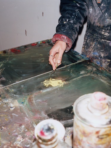 Francesca mixing materials in her studio