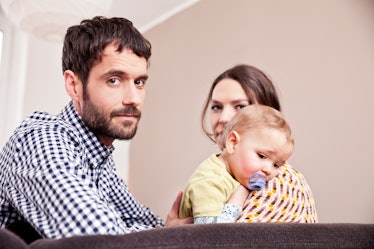 Tired mom and dad with toddler