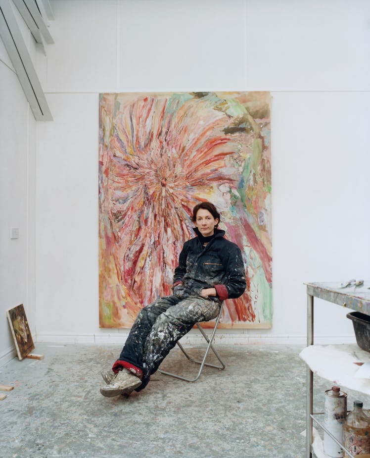 Francesca sitting in her studio with her work entitled "Speed Dial"