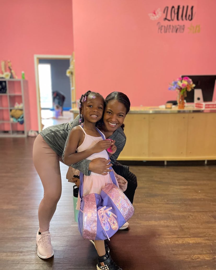 Erica and her daughter pose for a picture in a dance studio.