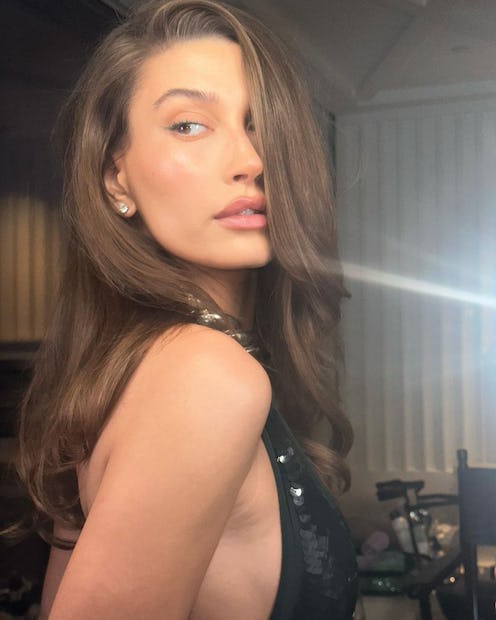 Hailey Bieber over shoulder brunette side part