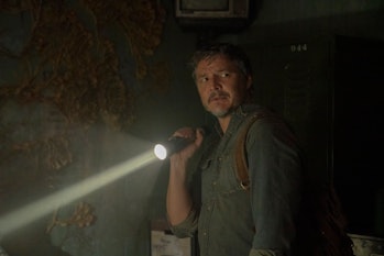 Joel Miller (Pedro Pascal) stands next to a fungus-covered wall in HBO's The Last of Us