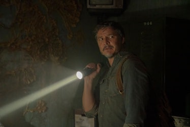 Joel Miller (Pedro Pascal) stands next to a fungus-covered wall in HBO's The Last of Us