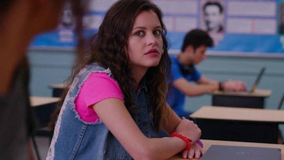 Max, a Leo, played by Sara Waisglass, sits in a classroom while filming Ginny & Georgia