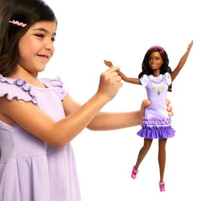 A child plays with My First Barbie Brooklyn. The larger doll is designed for smaller hands.