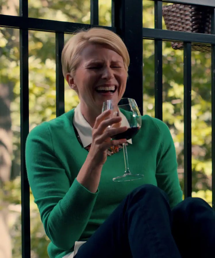 Ellen, a Cancer, played by Jennifer Robertson on Ginny & Georgia, laughs while drinking a glass of w...