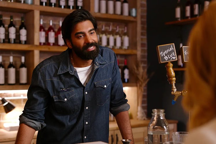 Raymond Ablack plays Joe, a Taurus, in Ginny & Georgia, smiles as he chats with a customer at his co...