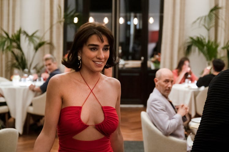 Lucia, whose zodiac sign is Aries, played by Simona Tobasco, smiles in a red dress in The White Lotu...