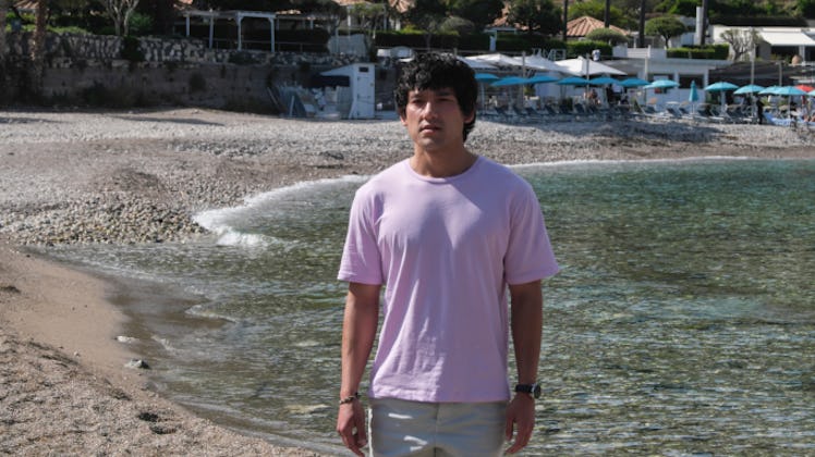 Ethan, whose zodiac sign is Virgo, played by Will Sharpe, stands on a beach during The White Lotus