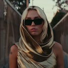 A shot of Miley Cyrus in her "Flowers" music video, which fans are asking where was Miley Cyrus' "Fl...