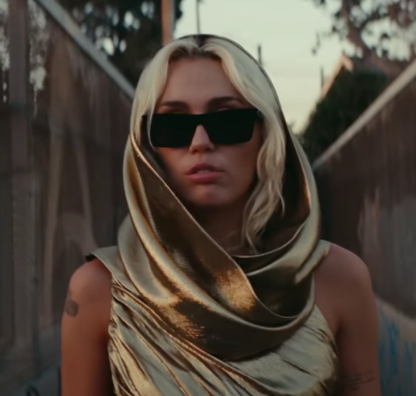 A shot of Miley Cyrus in her "Flowers" music video, which fans are asking where was Miley Cyrus' "Fl...