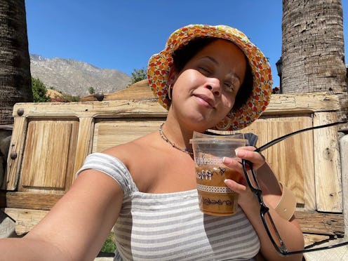 Beauty writer Natasha Marsh wearing a bucket hat and striped top on a sunny day.