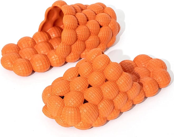 these quirky pillow slides have a bubble texture that doubles as foot massagers