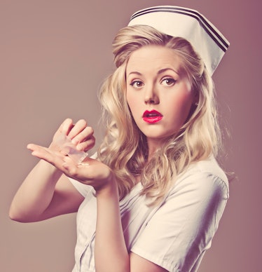 A retro sexy nurse taking pills out of a baggie.