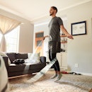 A man jumping rope at home in the living room.
