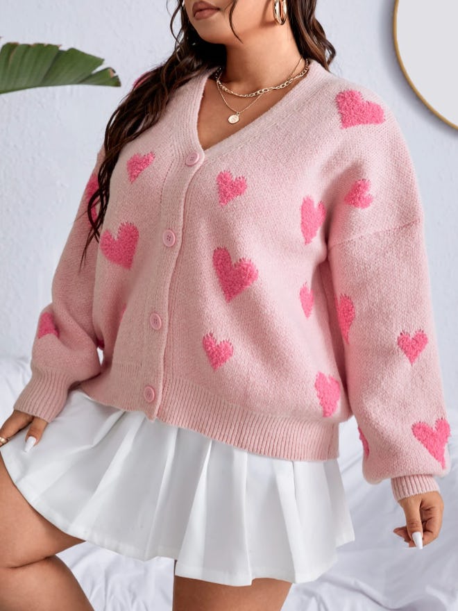 One Valentine's Day outfit idea is this Plus Heart Pattern Drop Shoulder Cardigan.