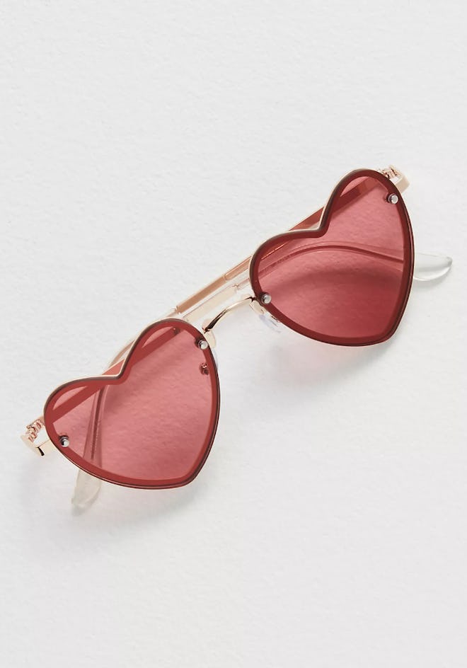 One Valentine's Day outfit accessory to wear are these Heart Eyes Sunglasses in Red.