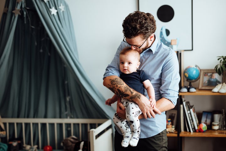 Man holding young child in arms