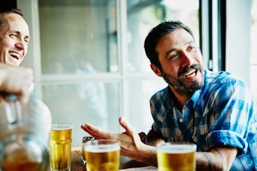 Man talking to friends over beers.