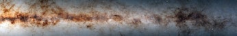 Color photo of the edge of a galactic disk, with brownish clouds of dust and bright stars