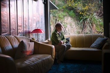 Man sitting on couch looking lonely