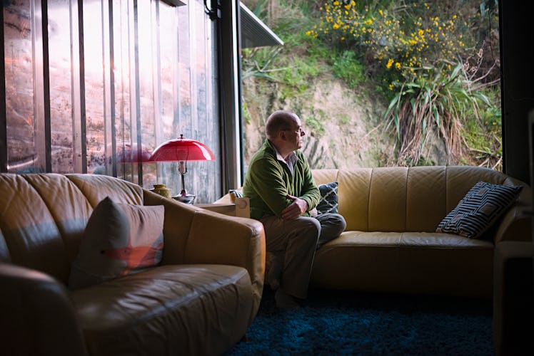 Man sitting on couch looking lonely