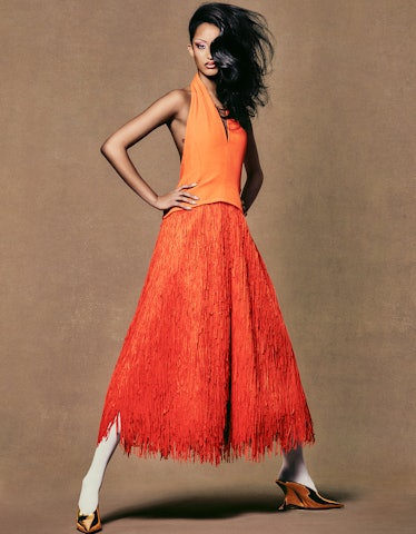 Model Mona Tougaard wearing an orange dress and shoes.