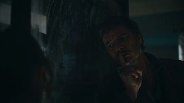 Joel (Pedro Pascal) holds a finger up to his lips in The Last of Us Episode 2