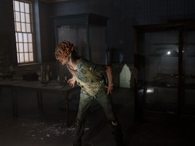 A Clicker stands in a dimly lit room in The Last of Us Episode 2