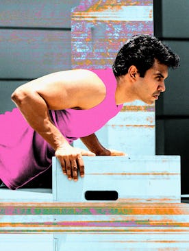 A man in a pink tank-top doing ab exercises at the gym