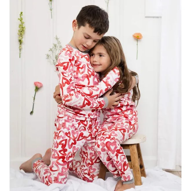kids hugging in valentine's day pajamas