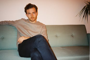 Man sitting on couch looking angry