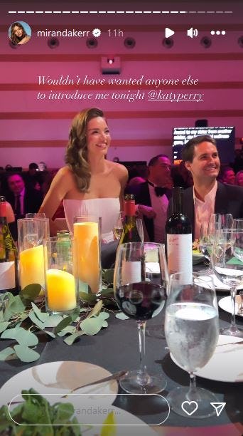 Miranda Kerr smiles as Katy Perry introduces her at the 2023 G&rsquo;Day USA Arts Gala.