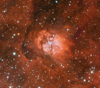 A visible-light image of the Sh2-54 nebula. There is a vibrant background sheen across the entire fi...
